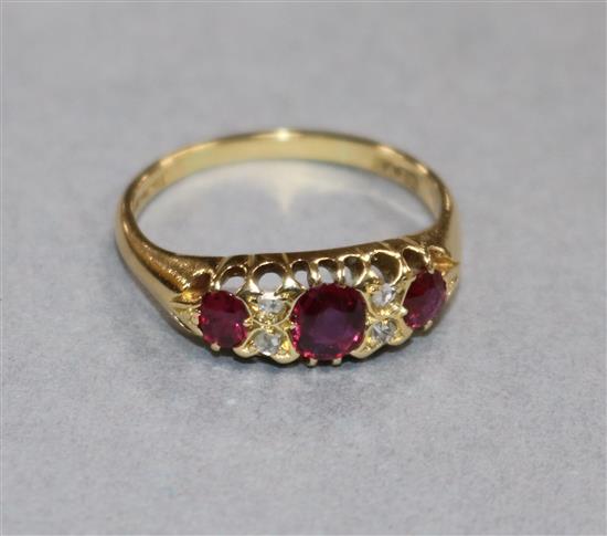 An early 20th century 18ct gold, ruby and diamond half hoop ring, size Q.